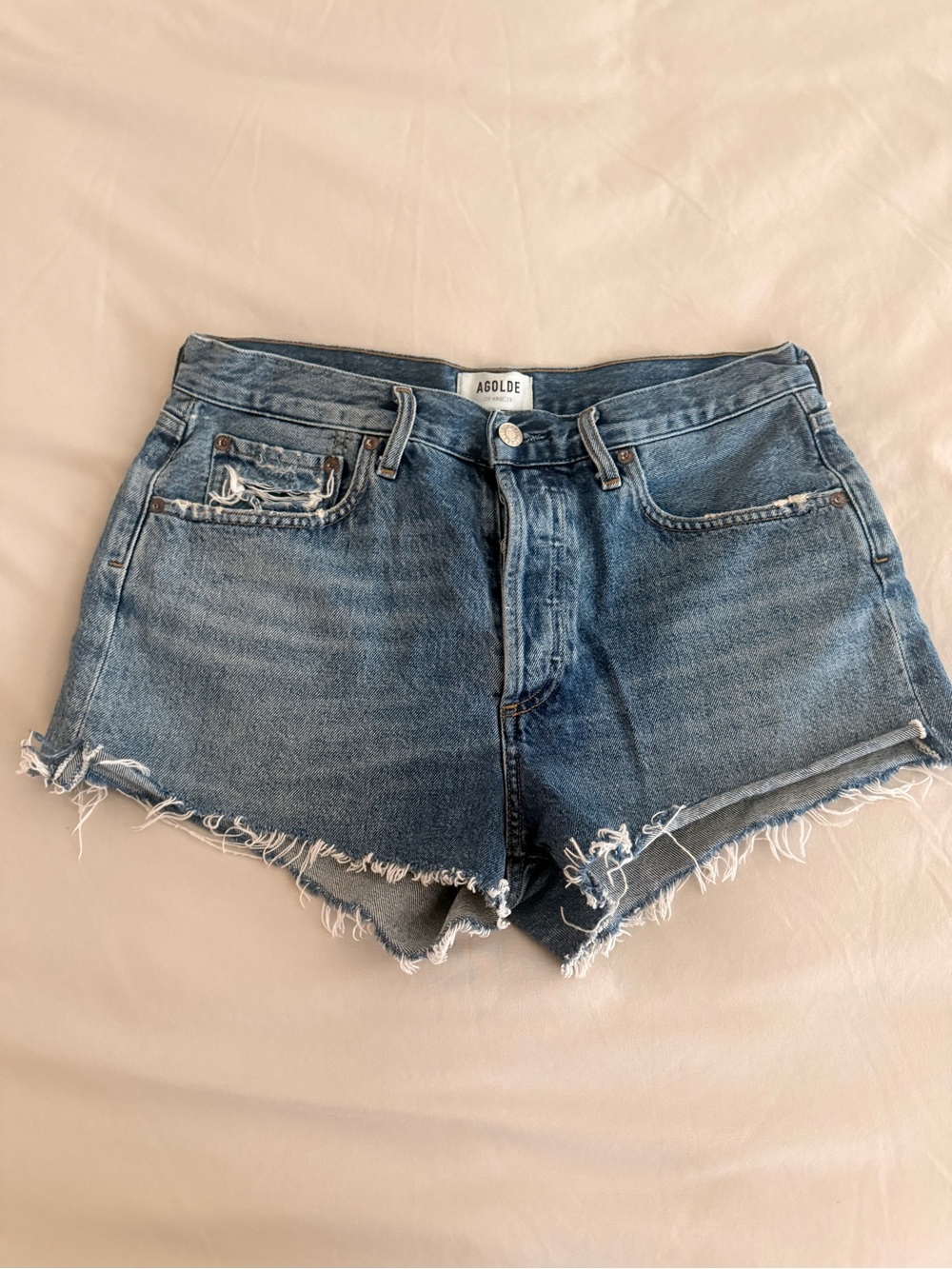 Agolde distressed medium blue denim cutoff shorts